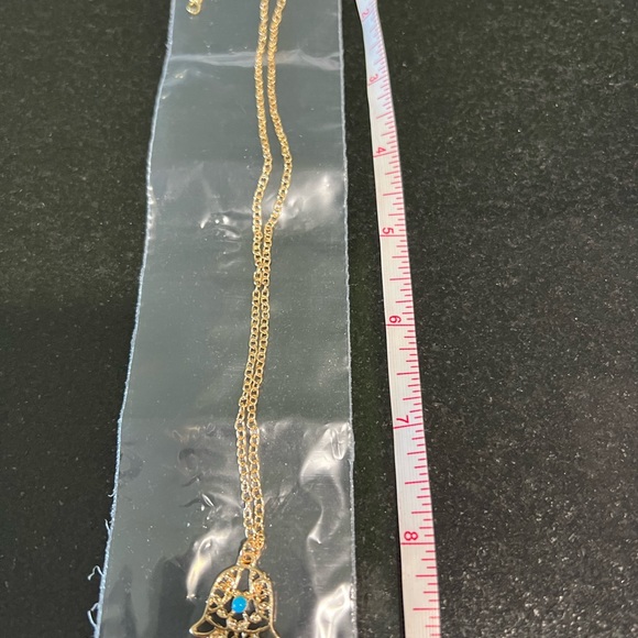 HAMSA IN GOLD TONE FILIGREE WITH A TURQUOISE COLORED STONE - Picture 4 of 8